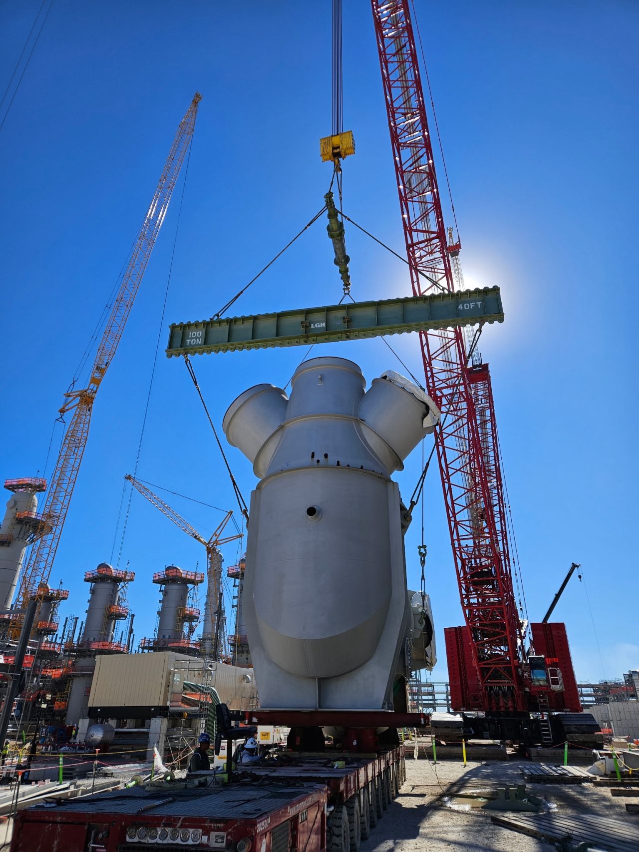 LGH rigging equipment rentals helping to lift a heavy load on an oil refinery jobsite.